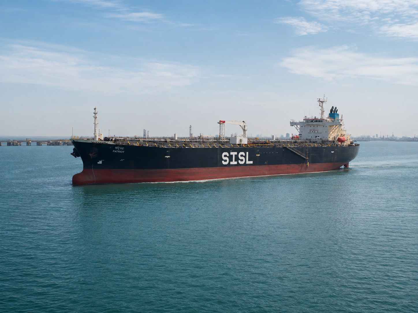 Product tanker PATRIOT under way in calm coastal water off a refinery terminal.
